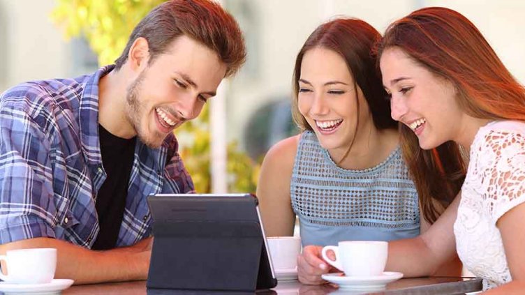 Image of friends laughing while seeing something