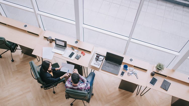 Facility managers in command center discuss building data