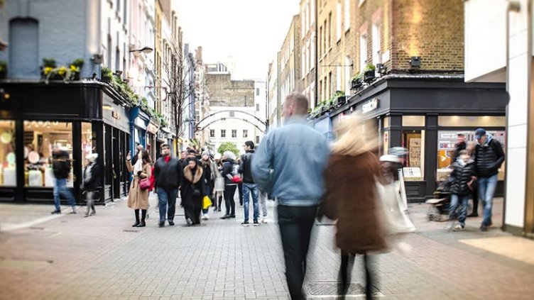 A crowd of pedestrians navigating a busy city street, highlighting the dynamic atmosphere of urban exploration.