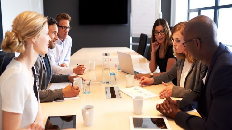 Group of young executives holding a work meeting in a conference room