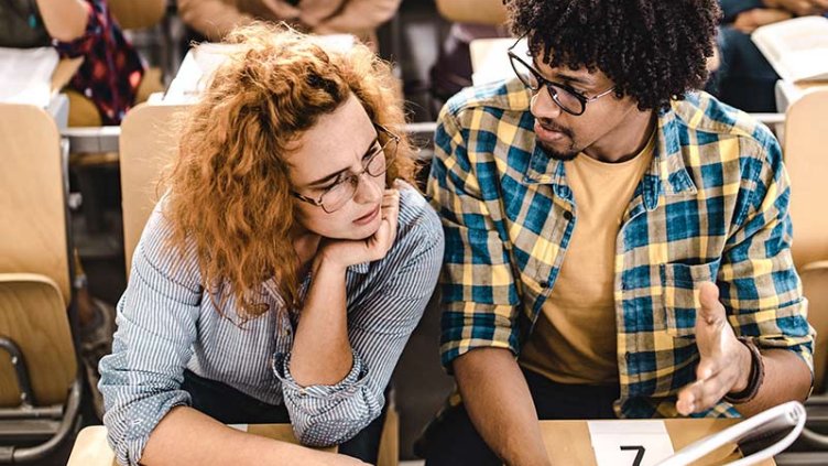 Two students studying together inside the university