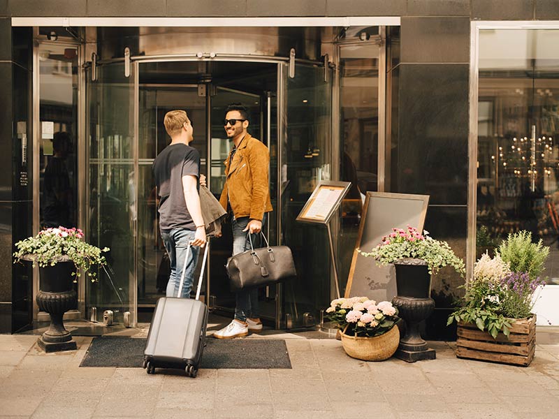 Men talking at the entrance of a hotel